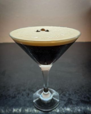 Cocktail drink in a V shaped glass