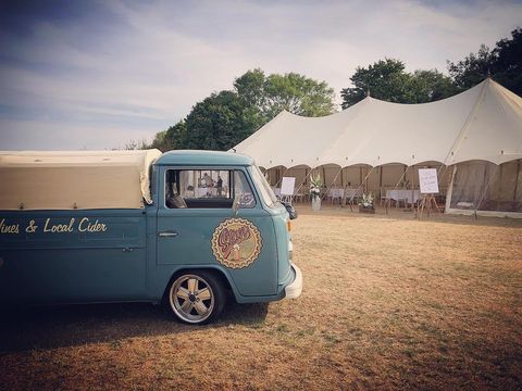 Wagonkered van with festival test in the background